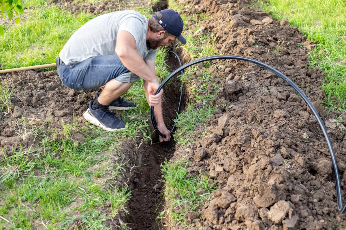 Commercial irrigation technician inspecting a sprinkler valve